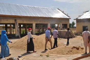 Mercy Corps Nigeria country director and director of programs on a visit to the skills acquisition center under construction in Bama.