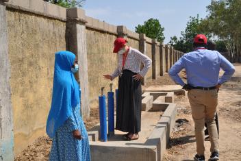 Mercy Corps Nigeria country director and director of programs visit one of the borehole water points constructed in Bama.