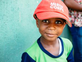 Child in mercy corps hat