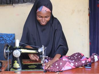 A young person operates a sewing machine