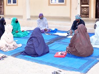 A group of people sit together.