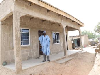 A person standing outside their home.