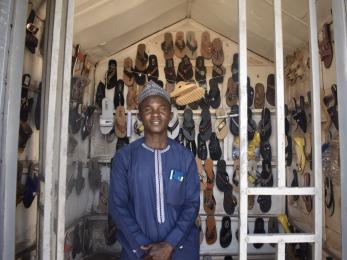 Safiya adamu, president of sangari multipurpose group, in the shoe shop he set up after collecting loan.