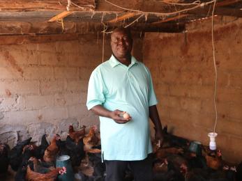 Paul msheliza with his poultry birds.