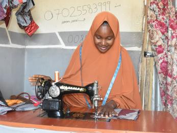 A person using a sewing machine.