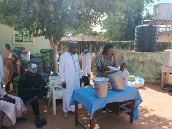 Program participants reviewing hygiene kits and 20 liter buckets distributed by mercy corps via health facilities to encourage communities without basic health supplies to follow hygiene guidelines.