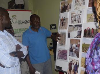 Dr. yusuf yakaubu yer ballahhe, showcasing pictures of his company’s activities in the northeast to usaid during the usaid field visits in adamawa state.